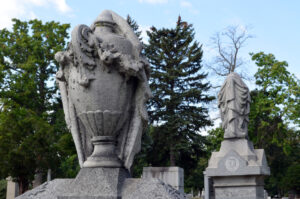 Two urn gravestones with stone draping.